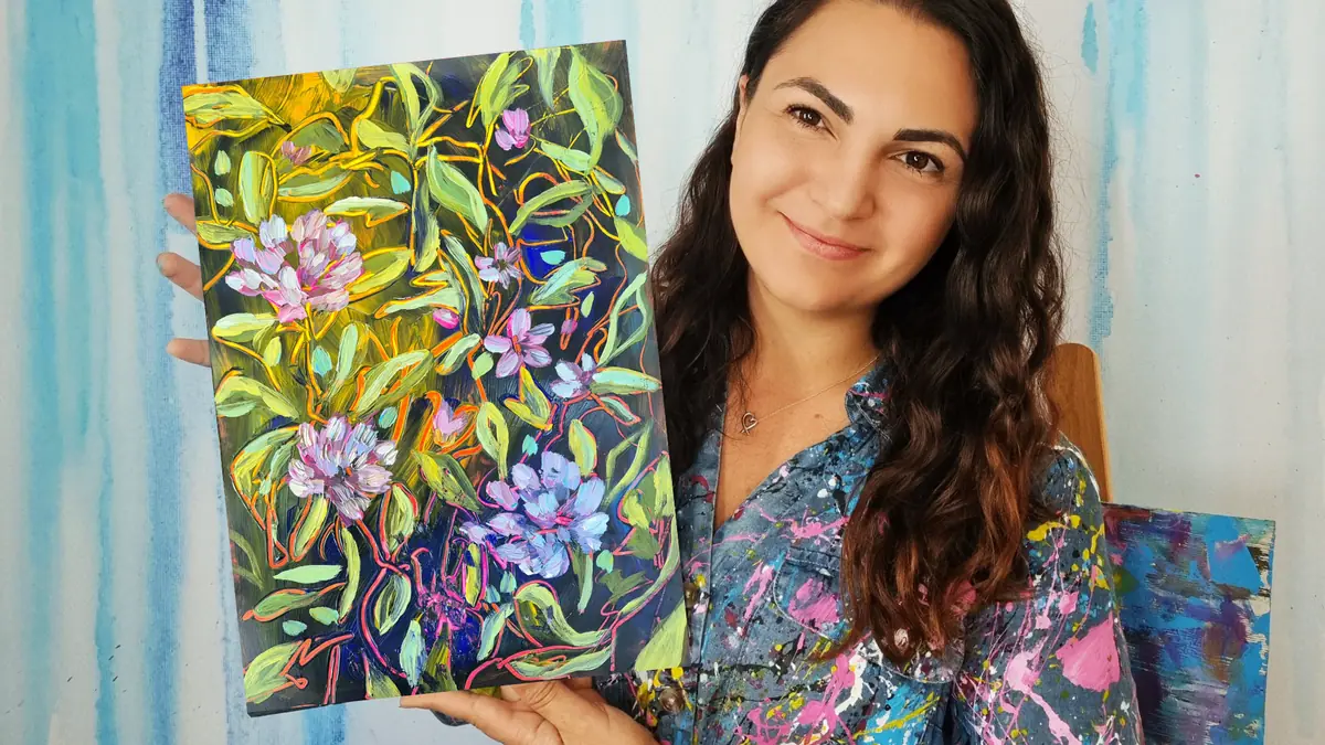 Jessa holding a finished floral painting