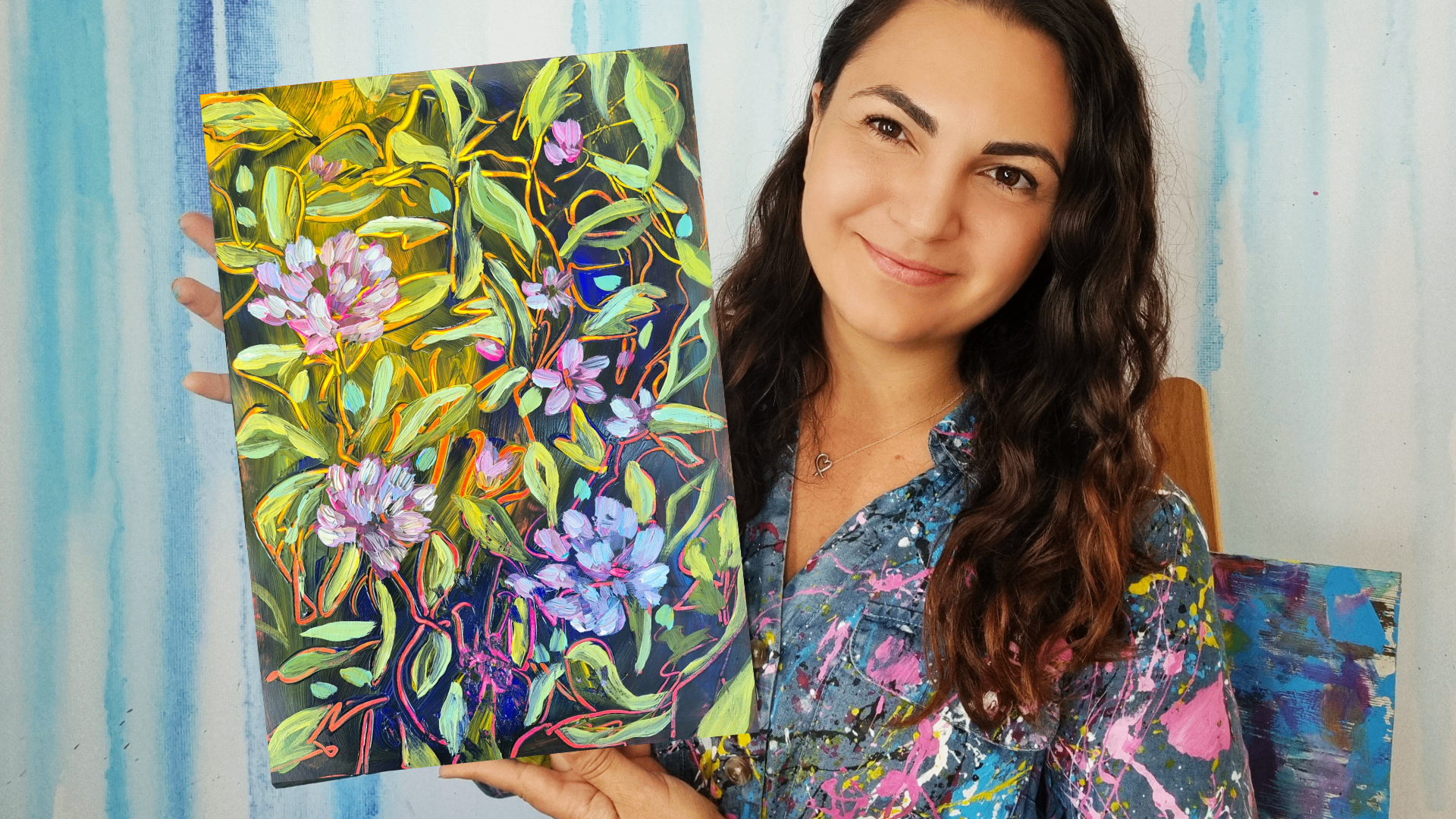 Jessa holding a finished floral painting